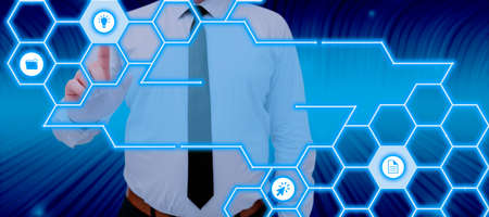 Businessman Pointing On A Pattern With Symbols And Presenting Important Information In A Futuristic...