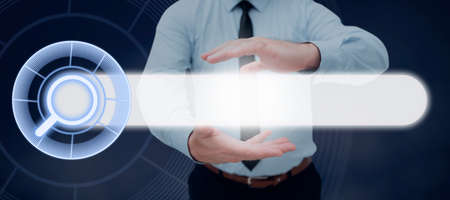 Businessman With Digitally Generated Search Bar Symbol In Hands Presenting Research And Development. Man With Searching Showing Modern Technology For New Ideas.の写真素材