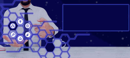 Businessman With A Touch Screen Displaying Digital Symbols In A Glowing Hexagon Pattern. Man In A...