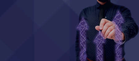 Businessman in suit holding notepad symbolizing successful teamwork accomplishing newest project plans. Man presenting notebook representing combined effort management.の写真素材