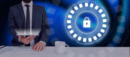 Businessman Holding A Tablet Displaying A Digital Lock In A Futuristic Round Design. Man In A Suit...