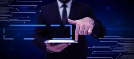 Businessman in suit holding tablet symbolizing successful teamwork accomplishing newest project...