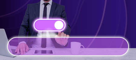 Businessman With A Latop And Tablet Pointing On The Power Button In A Futuristic Design. Man With Necktie Presenting Crucial Information And New Concepts In A Meeting.の写真素材