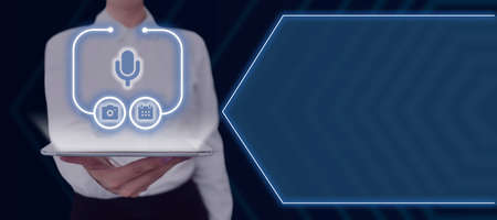 Businesswoman Holding A Tablet With A Mic Symbol And A Digital Display Of Glowing S With Futuristic...