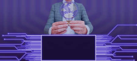 Businesswoman Holding A Light Bulb With Globe Image And Showing Glowing Lines In A Graphic Frame. Woman Presenting Global Communication And New Concepts.の写真素材
