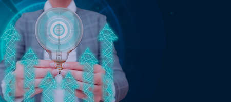 Businesswoman Holding A Light Bulb With Two Hands In A Creative Design With Arrows Going Up. Woman...