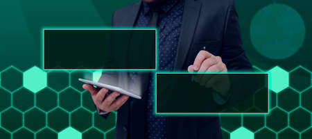 Male Professional Holding Tablet And Pen Pointing Digitally Generated Blank Display For Branding....