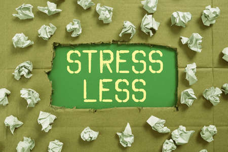 Hand writing sign Stress Less. Business concept Stay away from problems Go out Unwind Meditate Indulge Oneself Important Ideas Written Under Ripped Cardboard With Paper Wraps Around.の写真素材