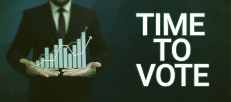 Hand writing sign Time To Vote. Concept meaning Election ahead choose between some candidates to govern Businessman in suit holding open palm symbolizing successful teamwork.の写真素材