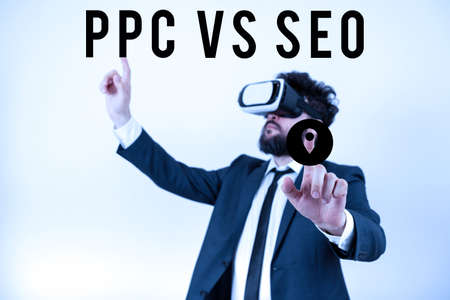 Sign displaying Ppc Vs Seo. Business overview Pay per click against Search Engine Optimization strategies Man Wearing Vr Glasses And Pointing On Important Messages With Both Hands.の写真素材