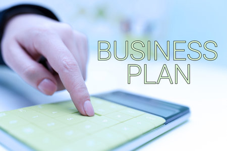 Text caption presenting Business Plan. Business overview Structural Strategy Goals and Objectives Financial Projections Businesswoman Pointing On Calculator On Desk With Notebook.の写真素材