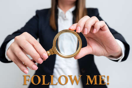 Inspiration showing sign Follow Me. Internet Concept Inviting a person or group to obey your prefered leadership Woman Having Magnifying Glass To Point Important Information.の写真素材