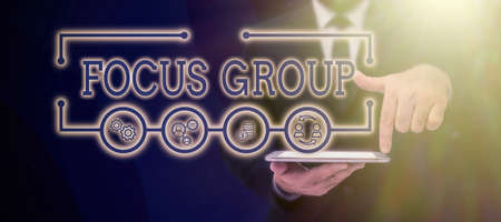 Text showing inspiration Focus Group. Business concept showing assembled to participate in discussion about something Businessman in suit holding tablet symbolizing successful teamwork.の写真素材