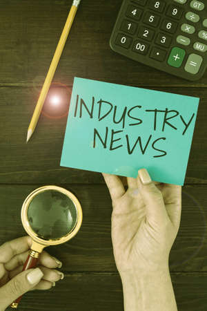 Inspiration showing sign Industry News. Business idea Technical Market Report Manufacturing Trade Builder Hands Of Woman With Blank Paper And Stationery For Advertisement.の写真素材