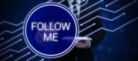 Conceptual display Follow Me. Business concept Inviting a person or group to obey your prefered leadership Lady in suit holding pen symbolizing successful teamwork accomplishments.の写真素材