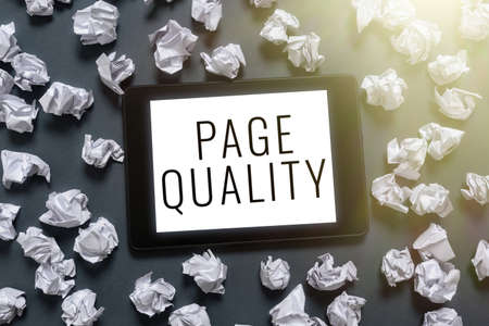 Conceptual display Page Quality. Business showcase Effectiveness of a website in terms of appearance and function Tablet Screen With Important Message On It Surrounded With Paper Wraps.の写真素材