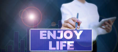 Text sign showing Enjoy Life. Conceptual photo Any thing, place,food or person, that makes you relax and happy Businessman in suit holding tablet symbolizing successful teamwork.の写真素材