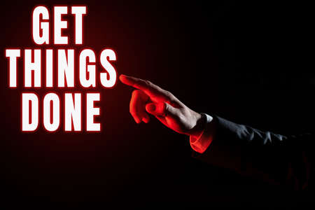 Text sign showing Get Things Done. Business approach To be in charge of do something leader leadership action Businessman Pointing Important Infortmations With One Finger.の写真素材