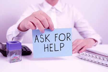 Sign displaying Ask For Help. Word for Request to support assistance needed Professional advice Businesswoman Holding Note With Important Message On Office Desk.の写真素材