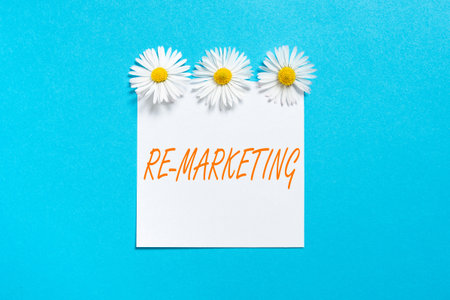 Inspiration showing sign Re Marketing. Business concept Strategy to reach potential customers in your website Sticky Note With Important Messages With Three Flowers Above.の写真素材