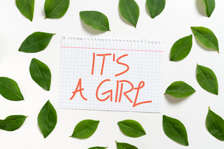 Text caption presenting It S Is A Girl. Internet Concept Expecting a baby cute pastel colors a lot of pink Notebook Sheet With Fresh Leaves For Creative Invitation And Cards.の写真素材