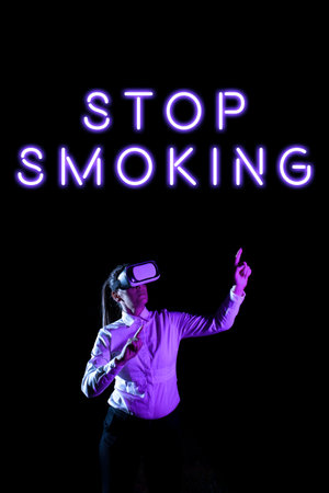 Text showing inspiration Stop Smoking. Business approach Discontinuing or stopping the use of tobacco addiction Woman Taking Professional Training Through Virtual Reality Goggles.の写真素材