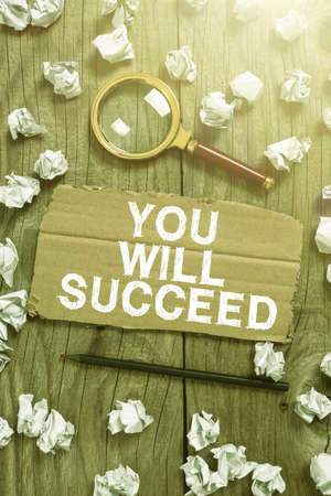 Sign displaying You Will Succeed. Word Written on Inspiration motivation to keep working be positive Cardboard With New Ideas With Paper Wraps, Pencil And Magnifier Around.の写真素材