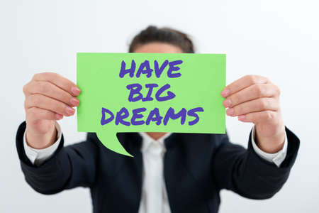 Conceptual caption Have Big Dreams. Word Written on Inspiration to imagine a great future development goals Businesswoman Holding Speech Bubble With Important Messages.の写真素材
