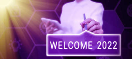 Text caption presenting Welcome 2022. Word Written on New Year Celebration Motivation to Start Cheers Congratulations Businessman in suit holding open palm symbolizing successful teamwork.の写真素材