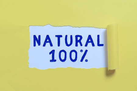 Text showing inspiration Natural 100. Conceptual photo Minimally processed and does not contain artificial flavors Important Information Written Underneath Ripped Piece Of Paper.の写真素材