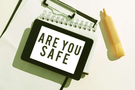 Sign displaying Are You Safe. Internet Concept Free from danger Not anticipating any Harm Hurt physically Tablet With Important Message Over Clipboard, Notebook And Marker.の写真素材