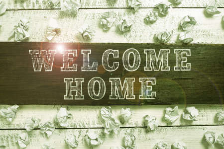 Handwriting text Welcome Home. Business showcase Expression Greetings New Owners Domicile Doormat Entry Important Ideas Written On Piece Of Wood With Paper Wraps Around On Floor.の写真素材