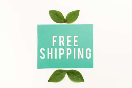 Handwriting text Free Shipping. Concept meaning Freight Cargo Consignment Lading Payload Dispatch Cartage Blank Color Paper With Leaves Arranged For Business Promotion.の写真素材