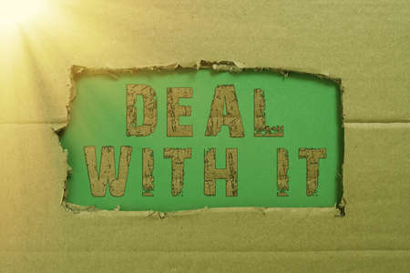 Text sign showing Deal With It. Word Written on Adapt to some particular situation and keep going forward Important Informations Written Underneath Ripped Cardboard.の写真素材