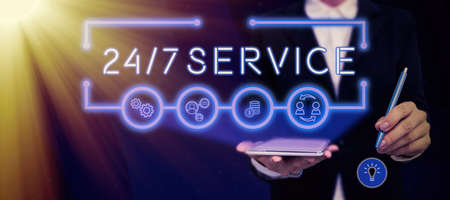 Inspiration showing sign 24/7 Service. Business idea Always available to serve Runs constantly without disruption Lady in suit holding pen symbolizing successful teamwork accomplishments.の写真素材