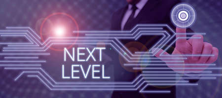 Handwriting text Next Level. Internet Concept having more than one floor and referring to after current Businessman in suit holding tablet symbolizing successful teamwork.の写真素材