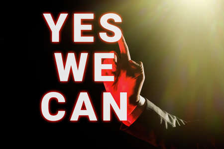 Hand writing sign Yes We Can. Internet Concept Motivation to do something have the enough strength to keep going Businessman Pointing Important Infortmations With One Finger.の写真素材