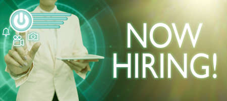 Inspiration showing sign Now Hiring. Concept meaning announcing that certain company seeking for new talents Lady in suit holding pen symbolizing successful teamwork accomplishments.の写真素材