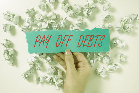 Sign displaying Pay Off Debts. Business showcase Payment for thing you have in debt Mortgages Investments Paper Wraps Underneath Piece Of Paper With Important Message.の写真素材
