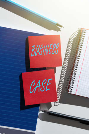 Text caption presenting Business Case. Business approach Proposition Undertaking Verbal Presentation New Task Important News Presented On Two Sticky Notes On Desk With Notebook And Pensの写真素材