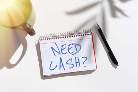 Inspiration showing sign Need Cash Question. Business approach asking someone if you need extra money or dont Notebook With Important Messages On Desk With Coffee And Pen.の写真素材