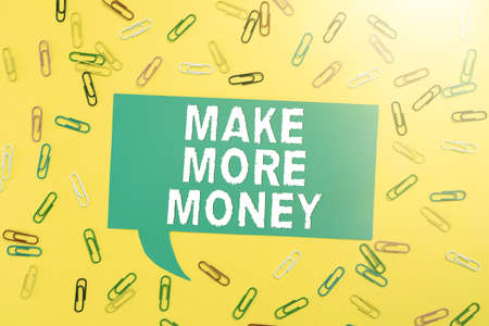 Text showing inspiration Make More Money. Business idea Increase your incomes salary benefits Work harder Ambition Colorful Paperclips Placed Around Speech Bubble With Important Information.の写真素材