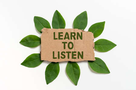 Writing displaying text Learn To Listen. Conceptual photo Able to understand what showing tells you be respectful Blank Cardboard Paper Surrounded With Leaves For Invitation Card.の写真素材