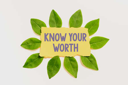 Writing displaying text Know Your Worth. Concept meaning Be aware of personal value Deserved income salary benefits Blank Color Paper Surrounded With Leaves For Invitation Card.の写真素材