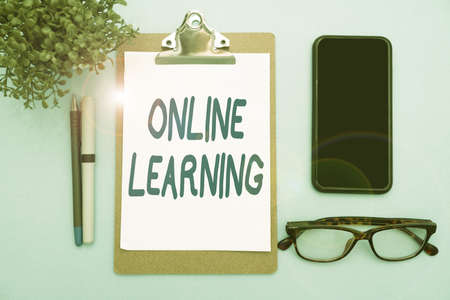 Hand writing sign Online Learning. Business showcase Larning with the assistance of the Internet and a computer Flashy School Office Supplies, Teaching Learning Collections, Writing Tools,の写真素材