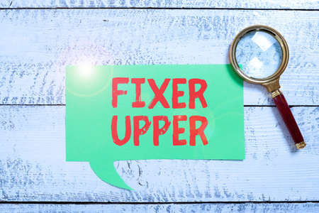 Text showing inspiration Fixer Upper. Concept meaning house in need of repairs used chiefly connection with purchase Businessman in suit holding tablet symbolizing successful teamwork.の写真素材