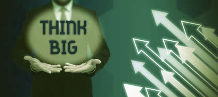 Writing displaying text Think Big. Concept meaning To plan for something high value for ones self or for preparation Businessman in suit holding notepad symbolizing successful teamwork.の写真素材