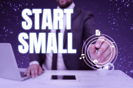 Writing displaying text Start Small. Business idea Small medium enterprises start up Business entrepreneurship Businessman in suit holding pen representing innovative thinking.の写真素材