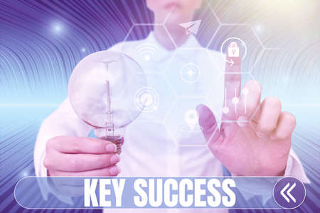 Text caption presenting Key Success. Business overview generally three to five areas that company may focus on Lady holding light bulb pointing finger upwards symbolizing success.の写真素材
