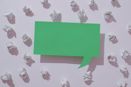 Speech Bubble On Floor With Important Information Written In With Paper Wraps Around. Dialogue Balloon On Ground With Crutial News Inside And Crumpled Notes All Over.の写真素材